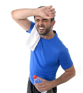 athletic sport man  holding water bottle wiping out sweat after