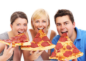 Friends eating huge pizza slices