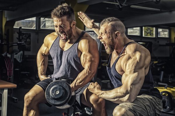 Bodybuilders pushing themselves with high intensity training