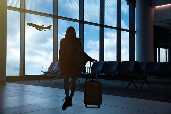 Fit woman in airport terminal with luggage