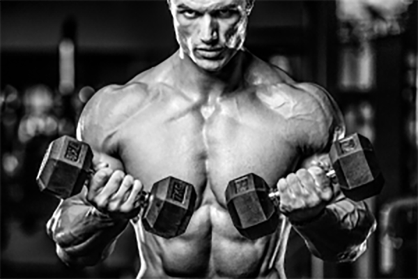 bodybuilder doing curls and building muscle with light weights