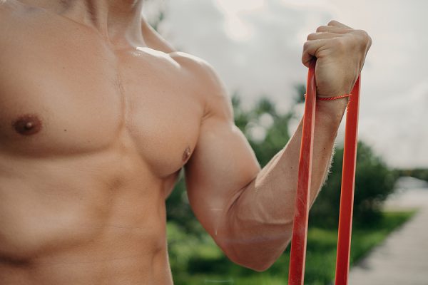 Man doing bicep curl with resistance band