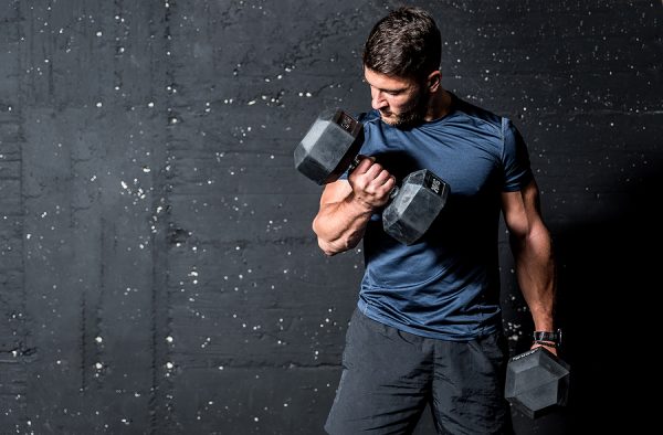 Man curling dumbbell with mind to muscle connection