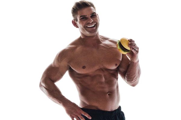 bodybuilder eating a burger