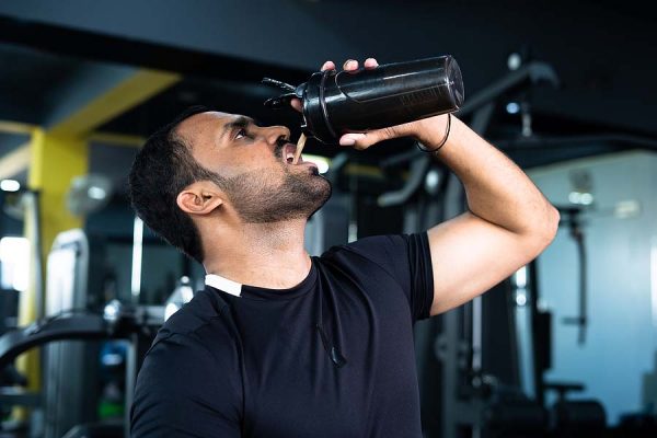 Bodybuilder drinking post workout shake