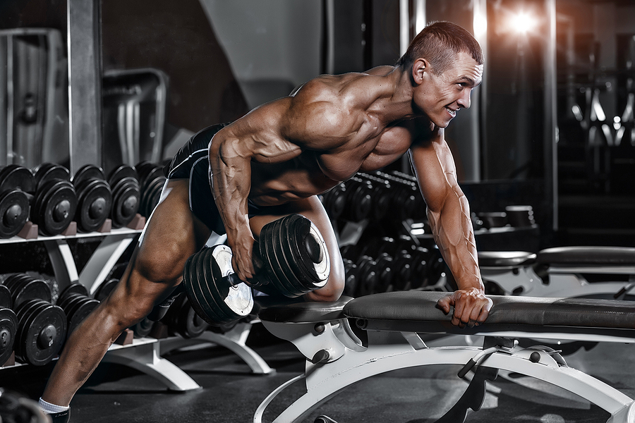 bodybuilder rowing a dumbell