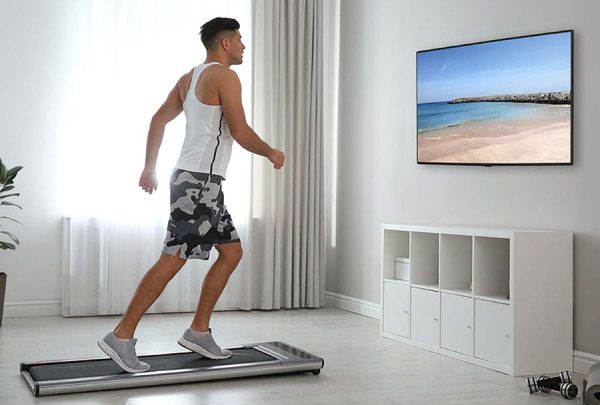 Walking on treadmill and watching TV at home