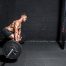 Man deadlifting in minimalist gym