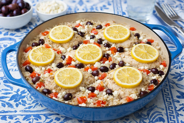 Greek chicken and rice with lemon slices in casserole dish