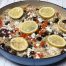 Greek chicken and rice with lemon slices in casserole dish