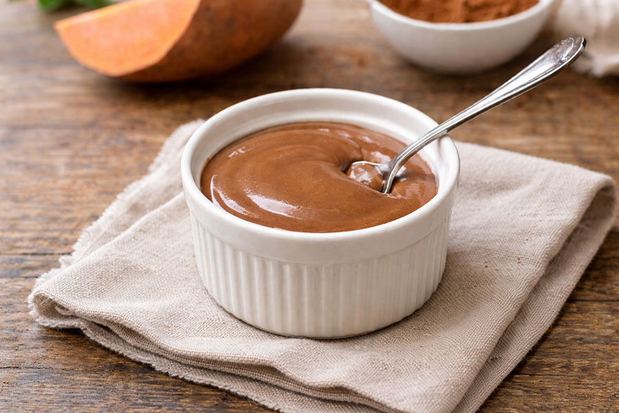 bowl of deep chocolate sweet potato protein pudding