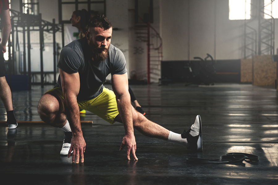 Man in the gym warming up before lifting