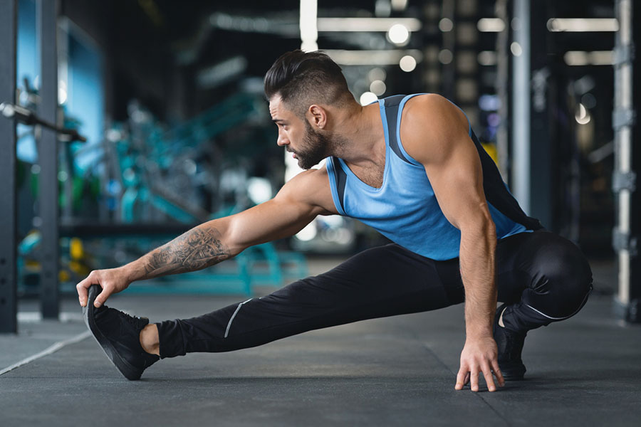 Man in gym warming up before lifting weights