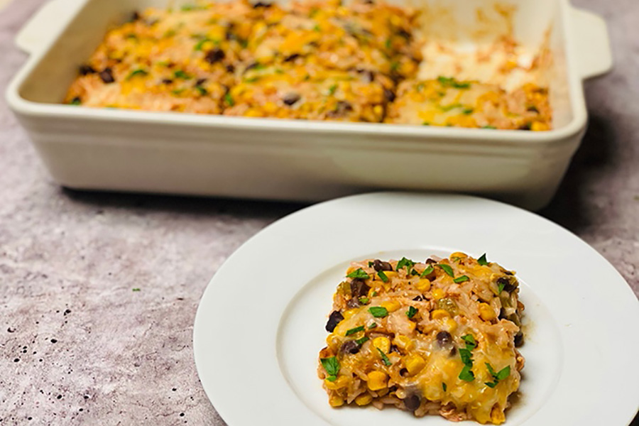 Slice of high protein chicken enchilada casserole on a plate