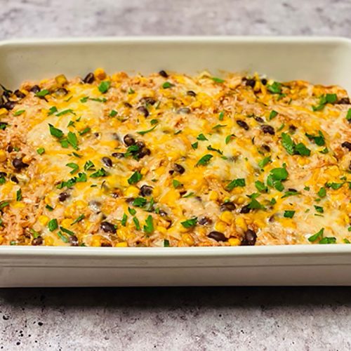 high protein chicken enchilada bake in casserole dish